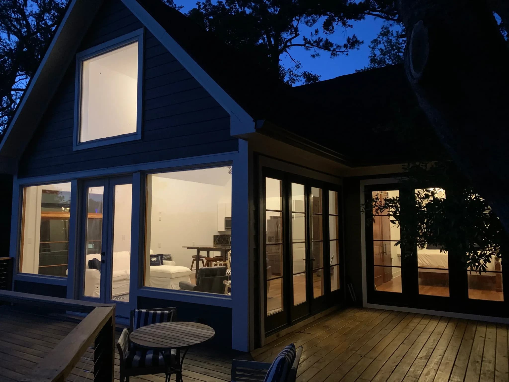 The Charleston Treehouse living room seen from the deck, full-height windows