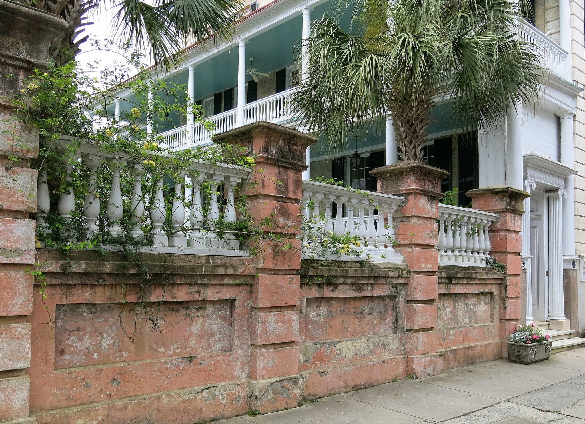 Historic Meeting Street in Charleston with wrought-iron gate and garden walls
